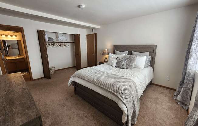 A bedroom with a large bed and a wooden headboard.