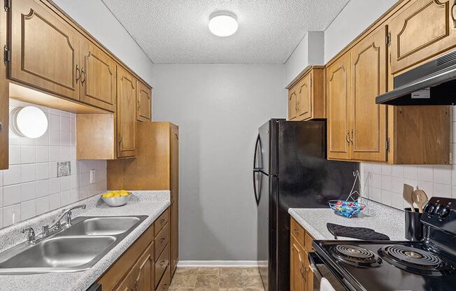 a kitchen with a stove sink and refrigerator