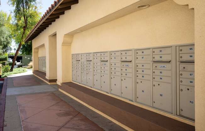 a row of lockers and a sidewalk in front of a building