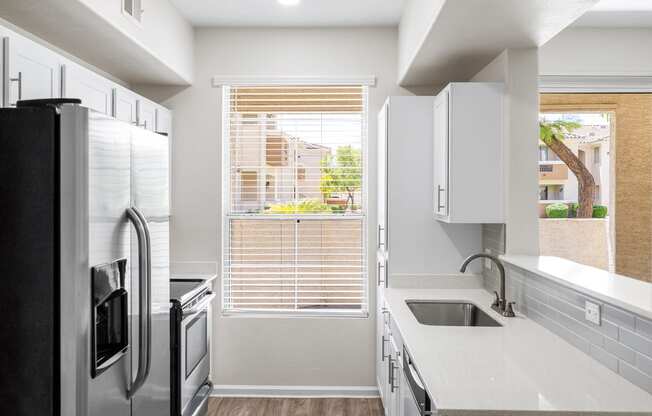 Renovated quartz countertops in updated units - Arrowhead Landing Apartments