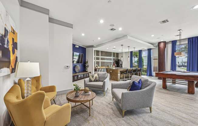 Stylish resident lounge with ample seating and contemporary art at Allusion at West University apartments in Houston, TX