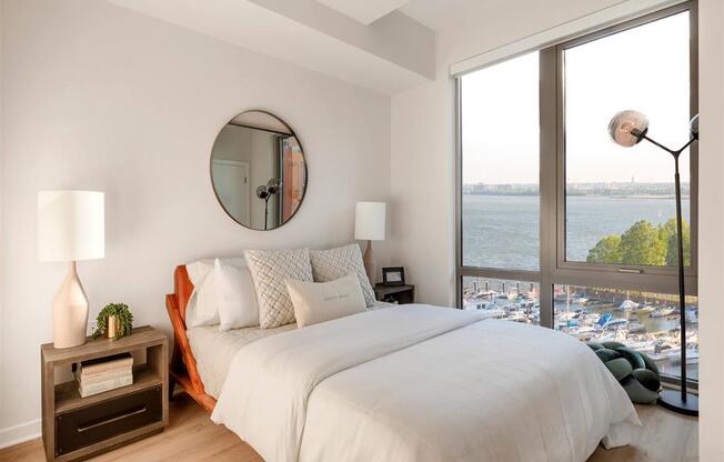 RiverPoint apartments in Washington, DC bedroom with floor to ceiling windows and sweeping waterfront views