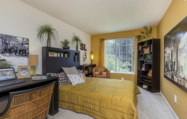 a bedroom with a large bed and a desk with a computer at Village Club of Rochester Hills, Shelby Township, MI 48317