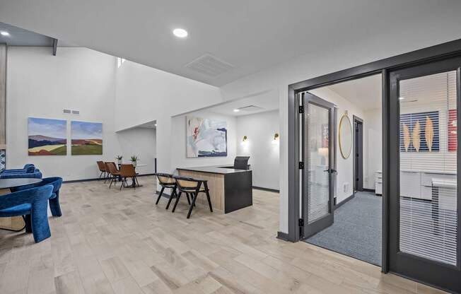 A room with a blue chair and a wooden floor.