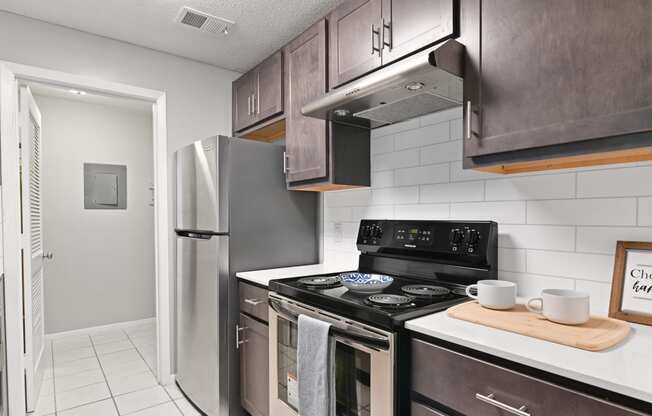 a kitchen with stainless steel appliances and a refrigerator