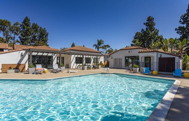 a swimming pool with a house in the background at La Jolla Blue, San Diego, CA 92122