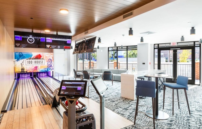 a bowling alley in a bowling club with tables and chairs at One Ten Apartments, New Jersey, 07310