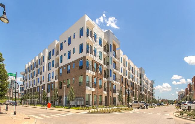 a large apartment building on the corner of a city street