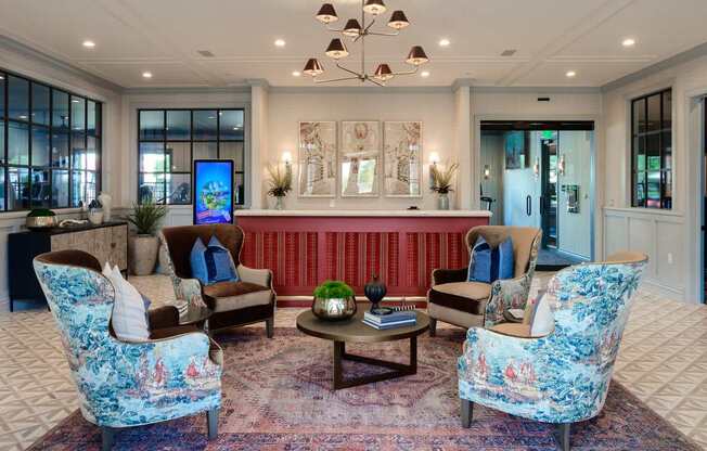 A living room with a sofa, two chairs and a coffee table.