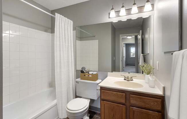 A bathroom with a white toilet, a white sink, and a white bathtub.