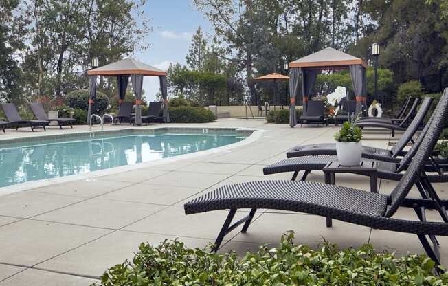 Escondido, CA Apartments For Rent - Alta Vista - Pool Area With Sun Lounge Chairs, Landscaped Greens, Cabanas, And Jacuzzi.