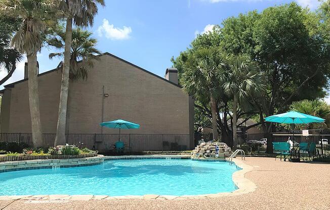 a group of lawn chairs sitting next to a pool of water