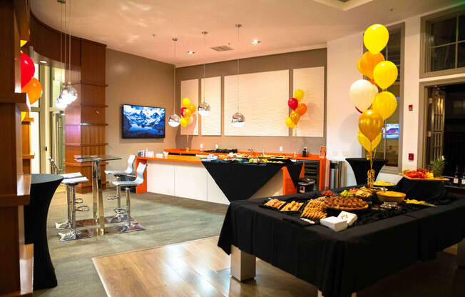 a buffet table with food and balloons in a room with a kitchen