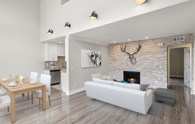 Living room with decorative stone wall and view of loft overhead.