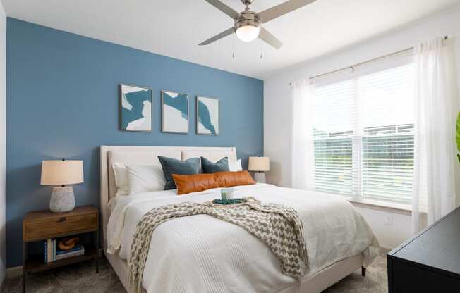 a bedroom with a large bed and a ceiling fan