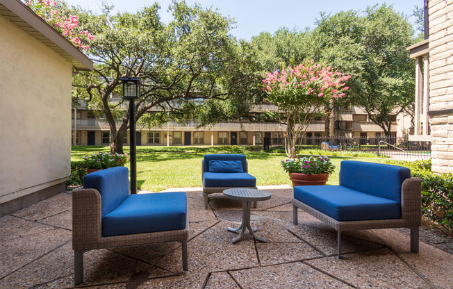 This is a photo of a sitting area in the courtyard at Harvard Square Apartments, in the Vickery Meadow neighborhood of Dallas, TX.