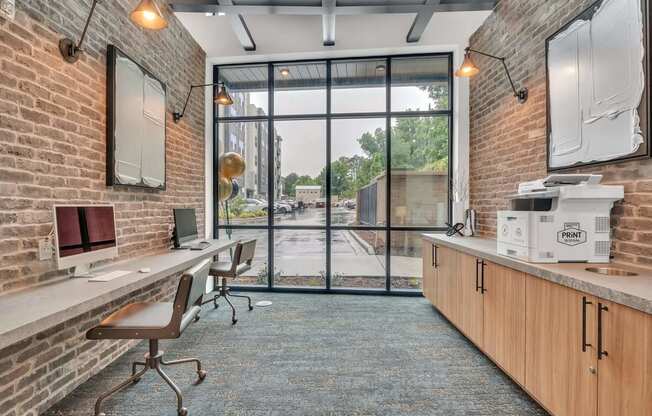 an office with a brick wall and a large window