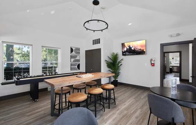 a living room with a bar and a table with chairs