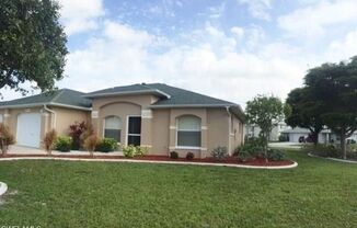 Experience this SE Cape Coral 2 bedroom 2 bath duplex with garage and lanai.