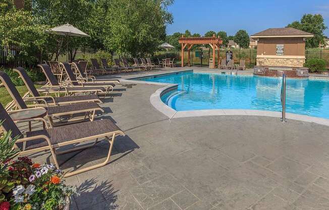 Lounge chair seating by an outdoor swimming pool at Stonepost Lakeside.