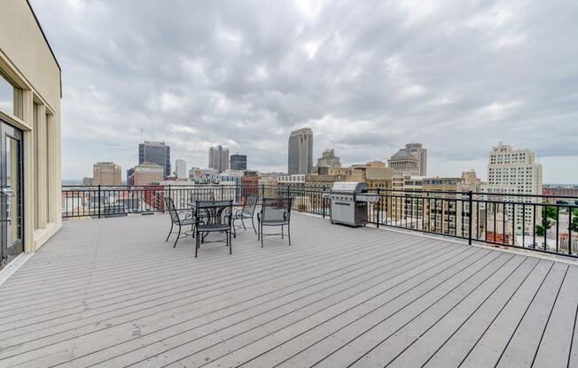 the deck has a view of the city and a table and chairs