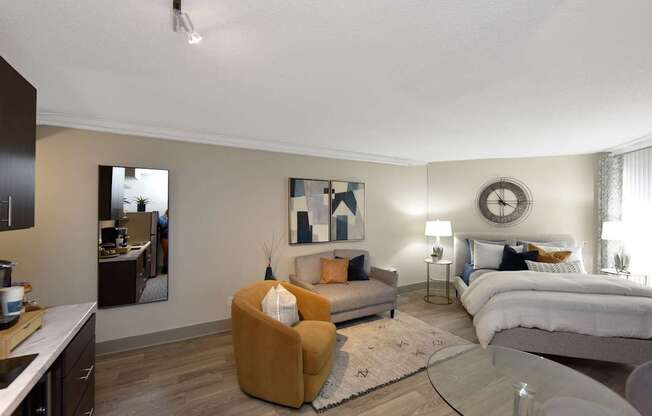 A modern bedroom with a large bed and a yellow armchair.