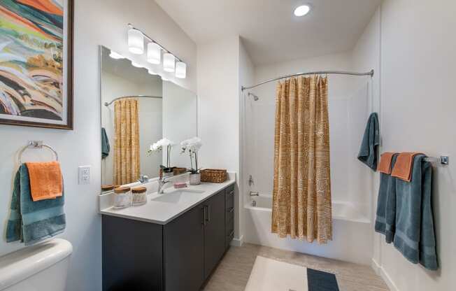 a bathroom with a shower and a sink and a mirror