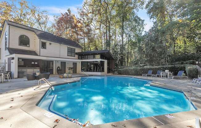 a swimming pool in the backyard of a house with a pool