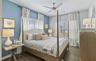 Bedroom with 4 poster bed dresser and nightstand