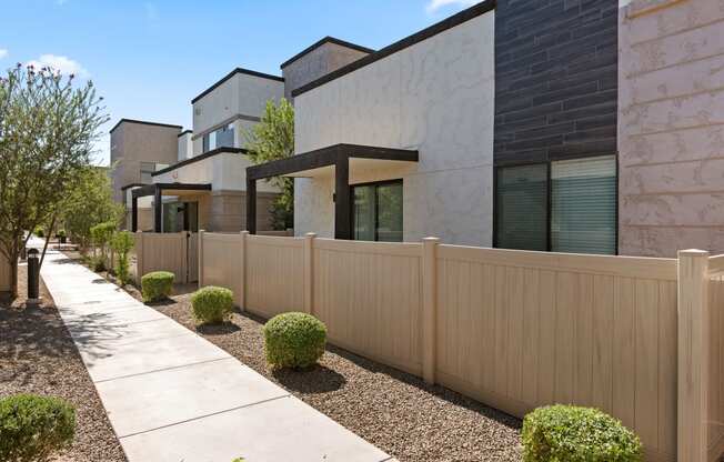 a wooden fence in front of a row of houses