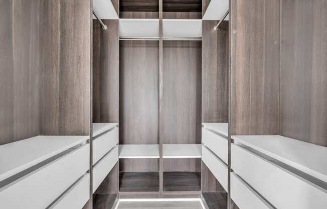 A long hallway with a bench on the side and a door at the end. at The Franklin Marlboro Apartments, New Jersey, 07746
