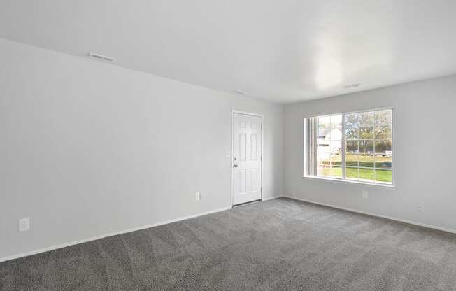 Spacious living room with natural light at Farmbrooke Manor Apartments in Clinton Township MI
