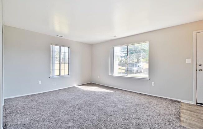 Spacious living room with natural light at Farmbrooke Manor Apartments in Clinton Township MI