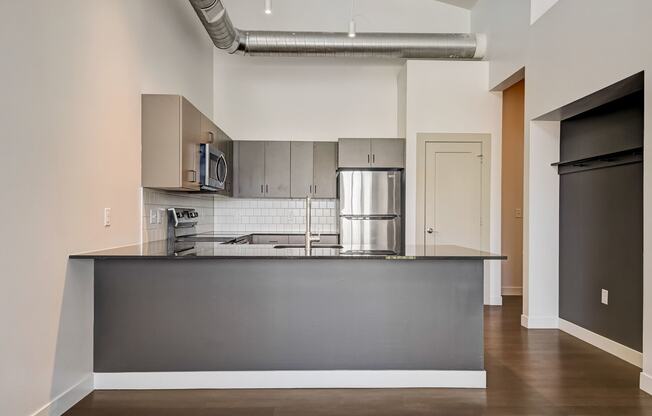 a kitchen with a large island and stainless steel appliances