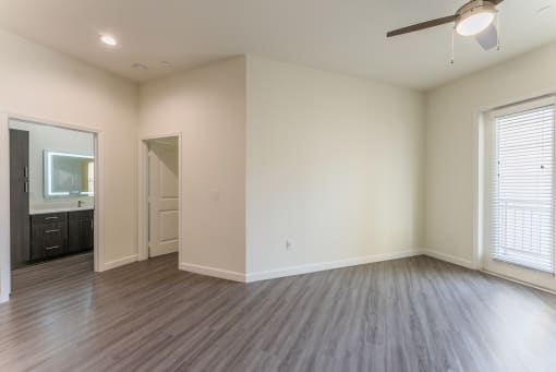 Beautiful Bright Bedroom with hardwood floors and a ceiling fan at Residences at 3000 Bardin Road, Grand Prairie, TX