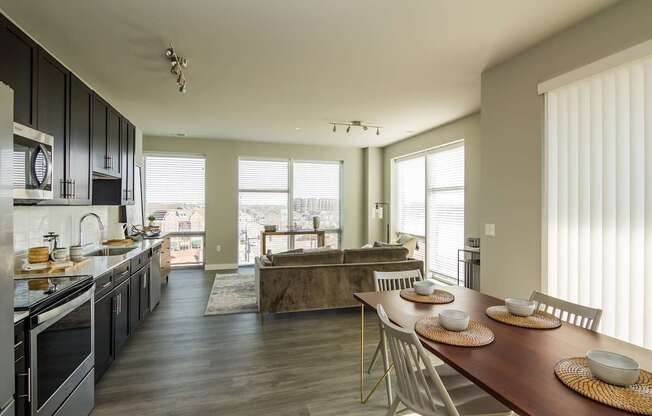 A modern kitchen with a dining table set for four.