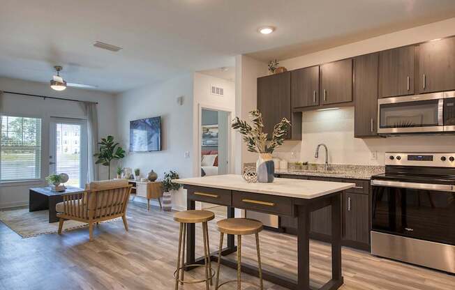 A modern kitchen with dark wood cabinets and stainless steel appliances.