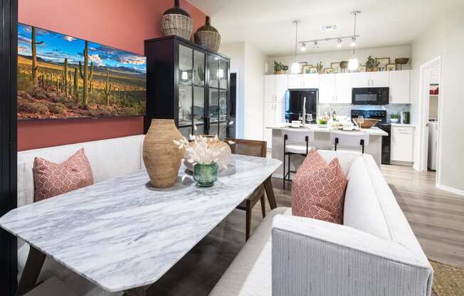 a living room with a dining room table and a kitchen