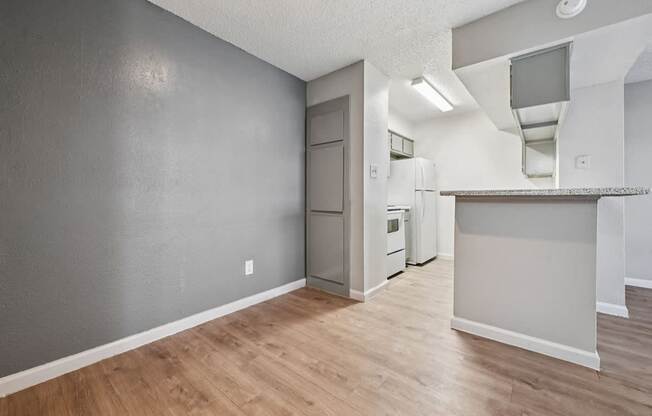 A kitchen area with a refrigerator, oven, and microwave.