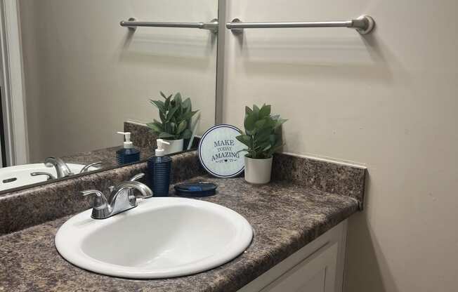 a small bathroom with a sink and a mirror