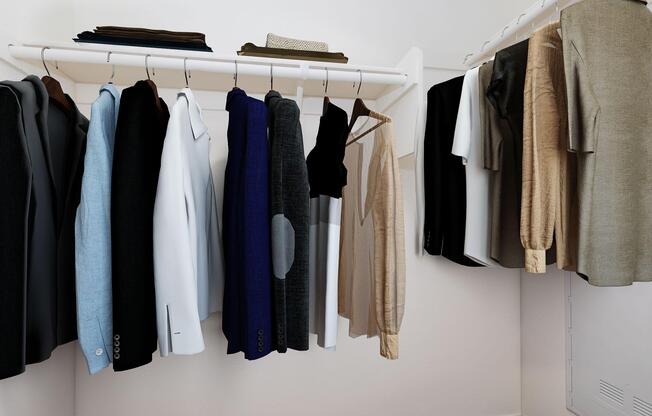A neatly organized wardrobe with a variety of shirts and jackets in different colors and styles, hanging on a white rod.