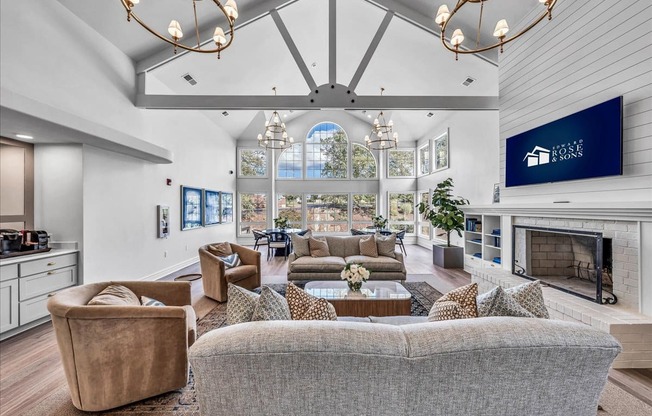 a living room with couches and chairs and a fireplace