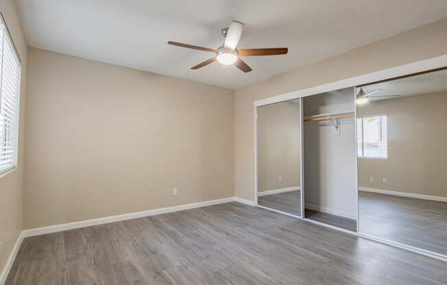 a bedroom with hardwood floors and a ceiling fan  at Sofia Apartments, Arizona