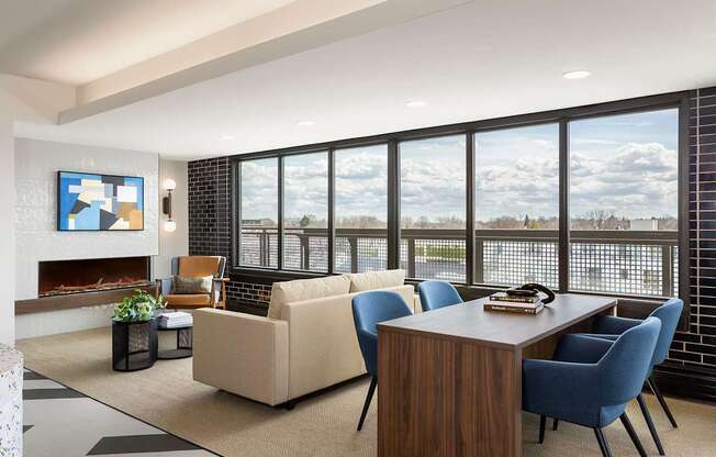 A sitting room with a couch and windows