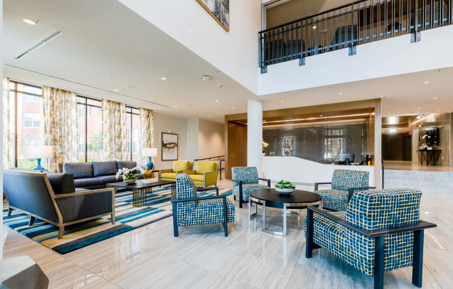 the lobby of a hotel with couches and chairs