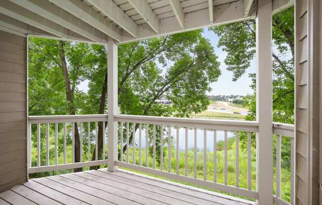 the view from the porch of a house overlooking a lake