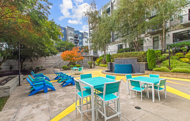 an outdoor patio with blue tables and blue chairs
