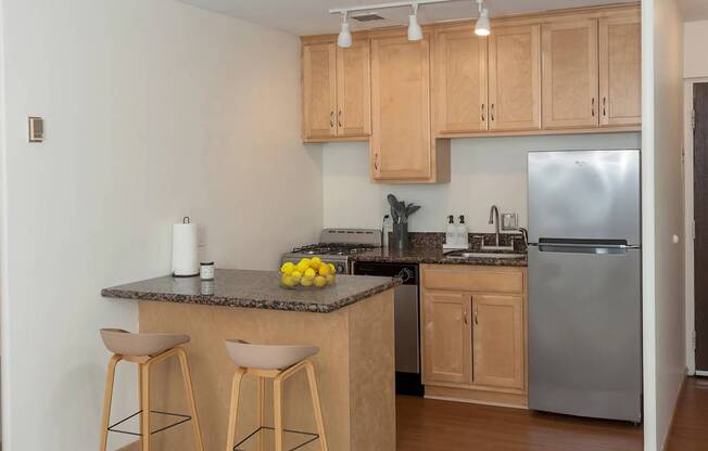 A kitchen with wooden cabinets and a granite countertop.