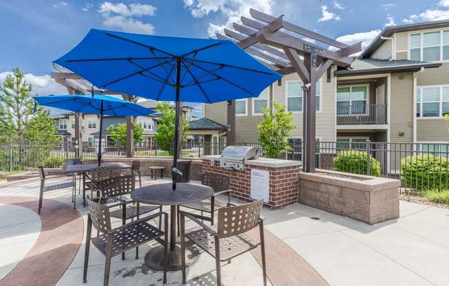 an outdoor patio with umbrellas and tables with chairs