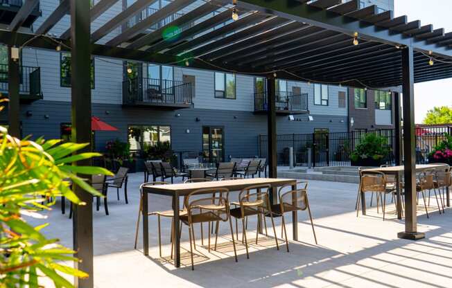 an outdoor patio with tables and chairs